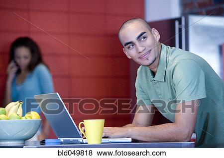 Stock Photo - African American man typing on laptop. Fotosearch