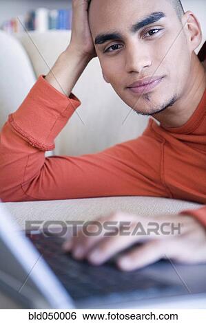 African American man typing on laptop View Large Photo Image Stock Photograph - African American man typing on laptop. Fotosearch