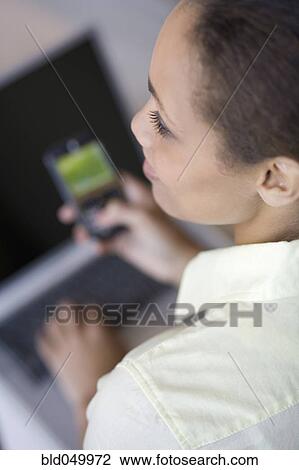 African American woman holding cell phone View Large Photo Image Stock Image - African American woman holding cell phone. Fotosearch