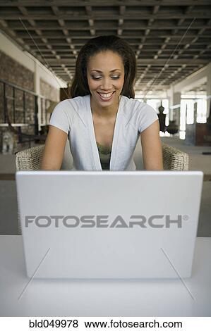 African American woman looking at laptop View Large Photo Image Stock Photo - African American woman looking at laptop. Fotosearch