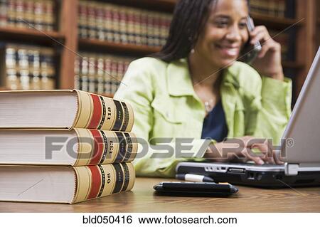 Stock Photograph - African American woman talking on cell phone. Fotosearch