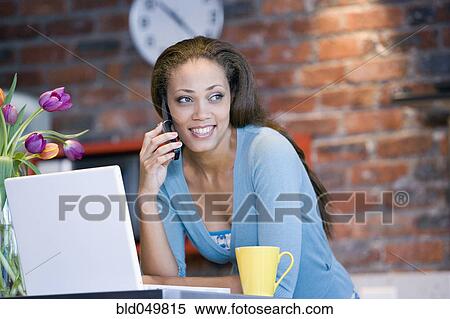 Stock Photography - African American woman talking on cell phone. Fotosearch