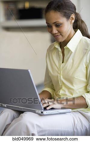 African American woman typing on laptop View Large Photo Image Stock Photo - African American woman typing on laptop. Fotosearch