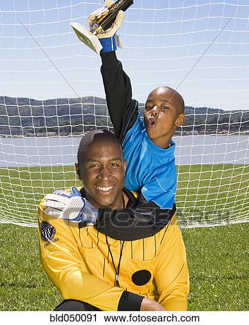 African boy and coach with soccer trophy View Large Photo Image Stock Image - African boy and coach with soccer trophy. Fotosearch