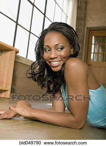 African woman laying on floor View Large Photo Image Stock Image - African woman laying on floor. Fotosearch