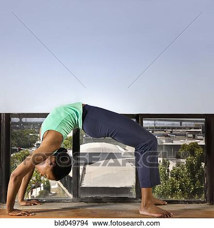 Picture - African woman practicing yoga. Fotosearch