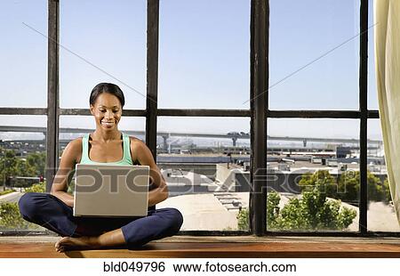 African woman typing on laptop View Large Photo Image Stock Photograph - African woman typing on laptop. Fotosearch