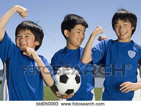 Stock Image - Asian boys with soccer ball. Fotosearch