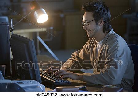 Asian businessman typing on computer View Large Photo Image Stock Image - Asian businessman typing on computer. Fotosearch