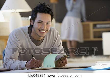 Picture - Asian businessman working on floor. Fotosearch