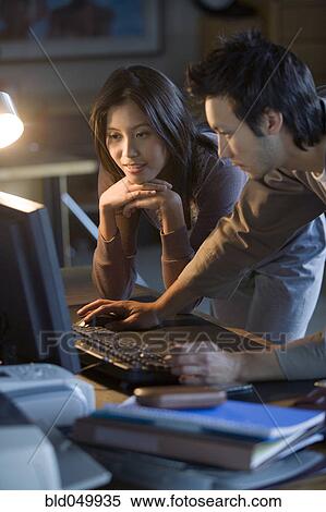 Asian businesspeople looking at computer View Large Photo Image Stock Photography - Asian businesspeople looking at computer. Fotosearch