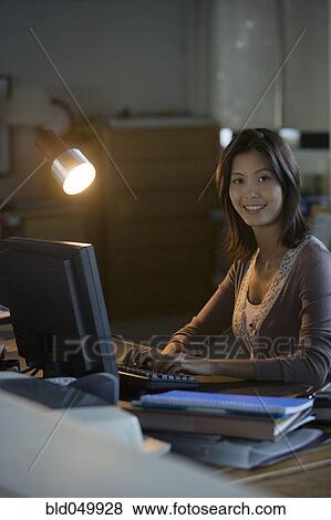 Asian businesswoman typing on computer View Large Photo Image Stock Photo - Asian businesswoman typing on computer. Fotosearch