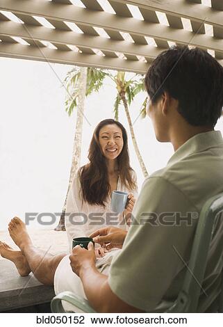 Asian couple drinking coffee View Large Photo Image Stock Image - Asian couple drinking coffee. Fotosearch