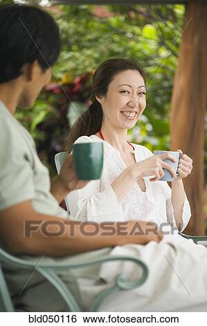 Asian couple drinking coffee View Large Photo Image Stock Photograph - Asian couple drinking coffee. Fotosearch
