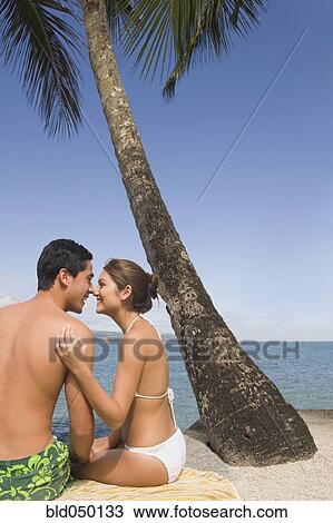 Asian couple sitting on beach View Large Photo Image Stock Image - Asian couple sitting on beach. Fotosearch