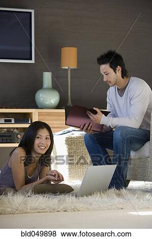 Asian couple working at home View Large Photo Image Stock Photo - Asian couple working at home. Fotosearch