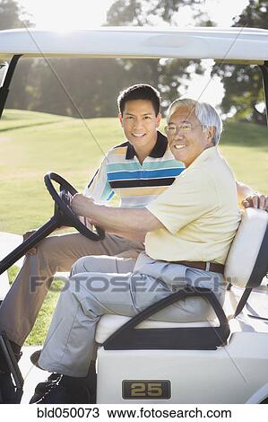 Asian father and adult son in golf cart View Large Photo Image Stock Image - Asian father and adult son in golf cart. Fotosearch