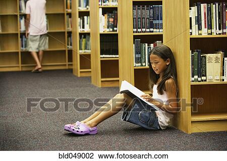 Asian girl reading library book View Large Photo Image Stock Image - Asian girl reading library book. Fotosearch