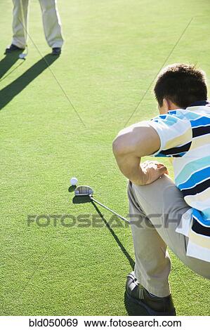 Stock Photo - Asian man playing golf. Fotosearch