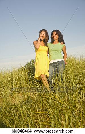 Picture - Asian mother and daughter in dune grass. Fotosearch