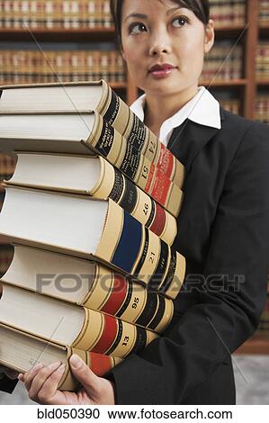Asian woman carrying stack of library reference books View Large Photo Image Stock Image - Asian woman carrying stack of library reference books. Fotosearch