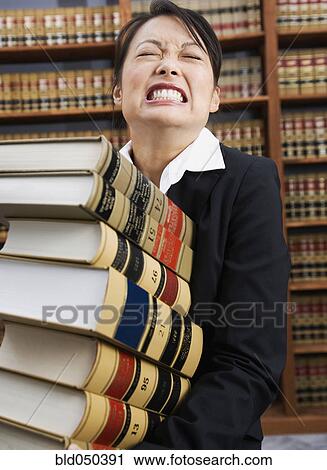 Asian woman carrying stack of library reference books View Large Photo Image Stock Image - Asian woman carrying stack of library reference books. Fotosearch