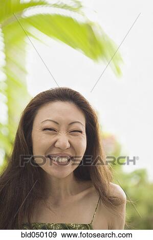 Stock Photo - Asian woman laughing. Fotosearch
