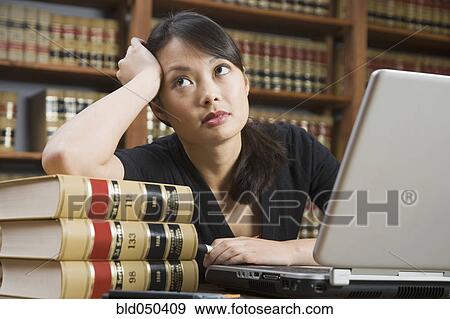 Asian woman leaning on stack of library books View Large Photo Image Stock Photo - Asian woman leaning on stack of library books. Fotosearch