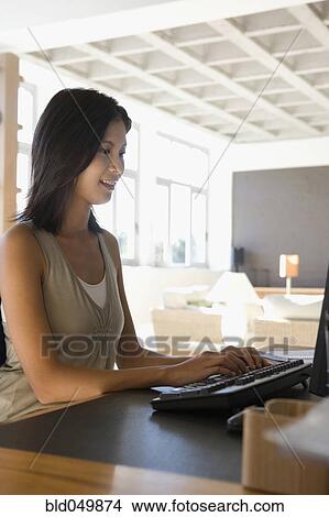 Asian woman typing on computer View Large Photo Image Picture - Asian woman typing on computer. Fotosearch