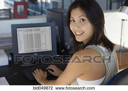 Asian woman typing on computer View Large Photo Image Stock Image - Asian woman typing on computer. Fotosearch