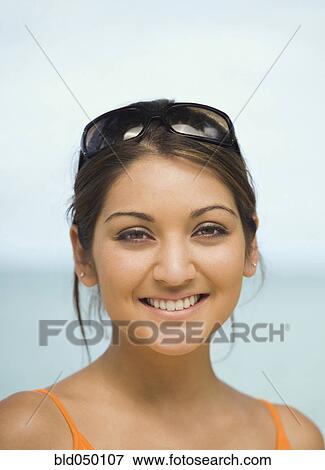 Asian woman with sunglasses on head View Large Photo Image Stock Photo - Asian woman with sunglasses on head. Fotosearch