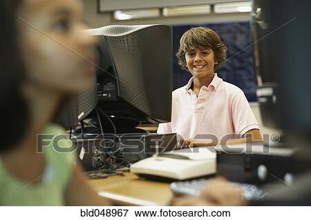 Stock Photo - Boy using school computer. Fotosearch