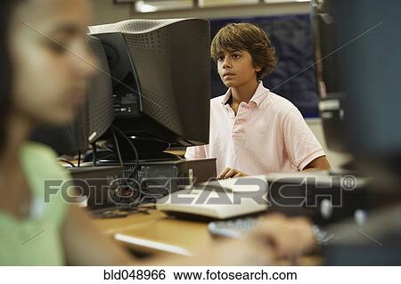 Stock Photograph - Boy using school computer. Fotosearch