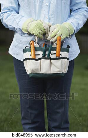 Chinese woman holding gardening supplies View Large Photo Image Stock Photography - Chinese woman holding gardening supplies. Fotosearch
