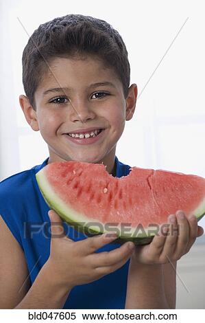 Hispanic boy eating watermelon View Large Photo Image Stock Photography - Hispanic boy eating watermelon. Fotosearch