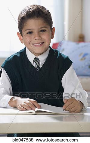 Hispanic boy writing in notebook View Large Photo Image Stock Photo - Hispanic boy writing in notebook. Fotosearch