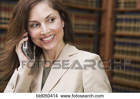 Hispanic businesswoman talking on cell phone View Large Photo Image Picture - Hispanic businesswoman talking on cell phone. Fotosearch