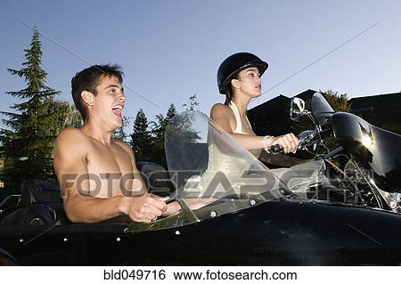 Stock Photograph - Hispanic couple on motorcycle with sidecar. Fotosearch
