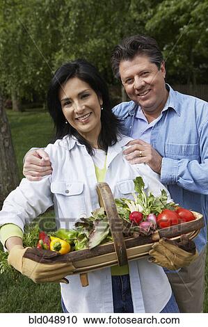 Hispanic couple with basket of vegetables View Large Photo Image Stock Image - Hispanic couple with basket of vegetables. Fotosearch