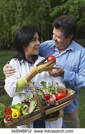 Hispanic couple with basket of vegetables View Large Photo Image Stock Image - Hispanic couple with basket of vegetables. Fotosearch