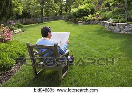 Hispanic man reading in backyard View Large Photo Image Stock Photography - Hispanic man reading in backyard. Fotosearch