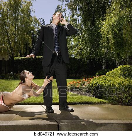 Hispanic woman in bikini grabbing businessman's leg View Large Photo Image Stock Image - Hispanic woman in bikini grabbing businessman's leg. Fotosearch