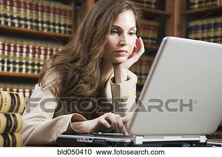 Hispanic woman looking at laptop View Large Photo Image Stock Image - Hispanic woman looking at laptop. Fotosearch