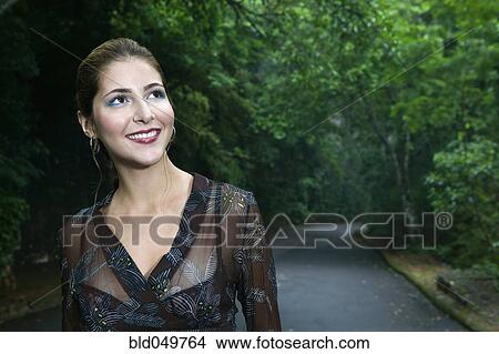 Hispanic woman on road in woods View Large Photo Image Picture - Hispanic woman on road in woods. Fotosearch