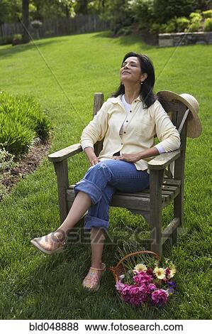 Hispanic woman relaxing in backyard View Large Photo Image Stock Photo - Hispanic woman relaxing in backyard. Fotosearch