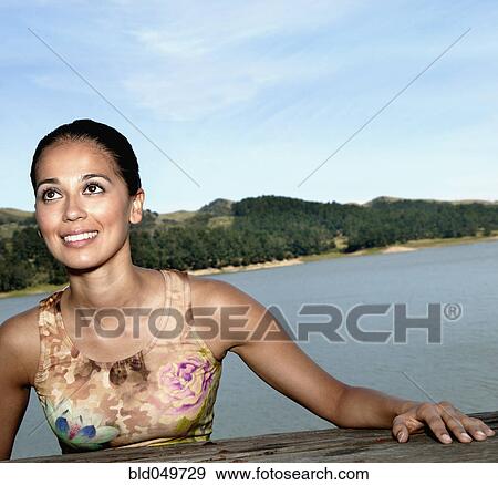 Stock Photo - Hispanic woman with water in background. Fotosearch