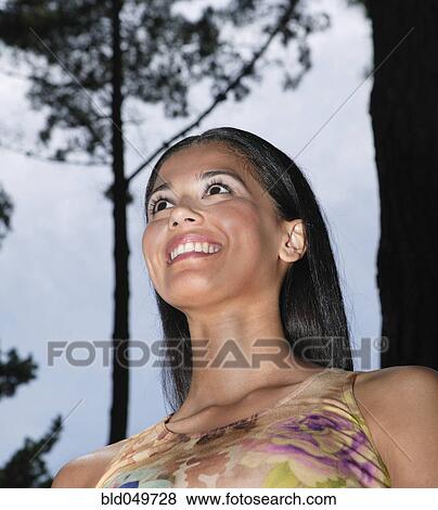 Stock Photo - Low angle view of Hispanic woman. Fotosearch