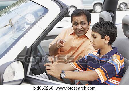 Middle Eastern father and son in new car View Large Photo Image Stock Image - Middle Eastern father and son in new car. Fotosearch