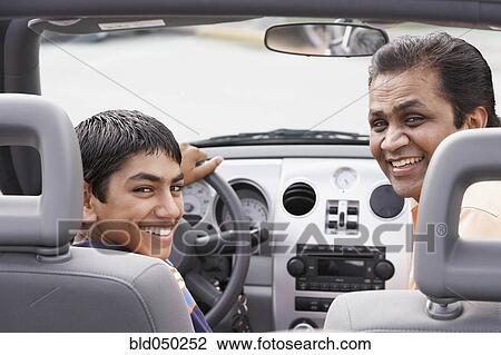 Middle Eastern father and son in new car View Large Photo Image Stock Image - Middle Eastern father and son in new car. Fotosearch
