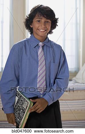 Mixed Race boy holding school books View Large Photo Image Stock Image - Mixed Race boy holding school books. Fotosearch